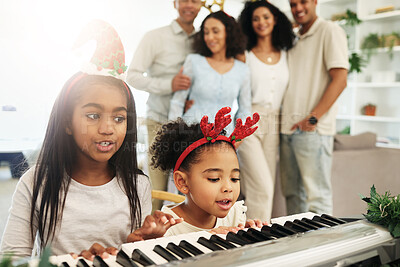 Buy stock photo Children, singing and Christmas piano songs on a holiday or vacation excited in a home or house with a happy family. People, celebrate and kids make music or song together in celebration and bonding