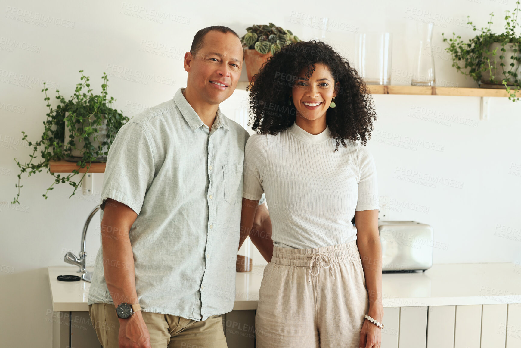 Buy stock photo Happy, love and portrait of a couple in the kitchen of their new modern home together in Mexico. Happiness, smile and mature married man and woman bonding and embracing while standing in their house.