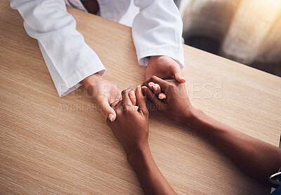 Buy stock photo Hands holding, trust and doctor comfort a patient for support, cancer and help in a hospital or clinic office. Unity, top view and healthcare professional consulting a person in kindness for advice