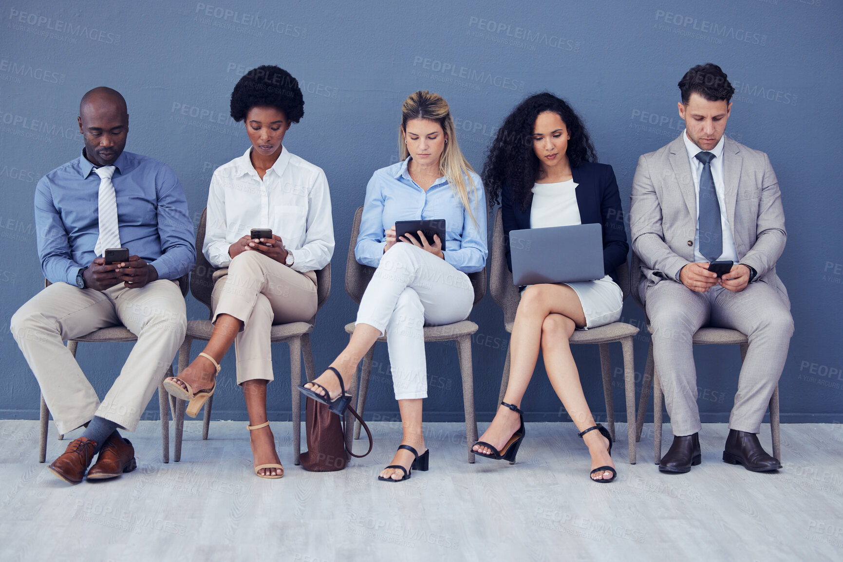 Buy stock photo HR, technology and business people waiting in line for an interview during the recruitment process. Resume, diversity or hiring with a man and woman employee group sitting in a human resources row