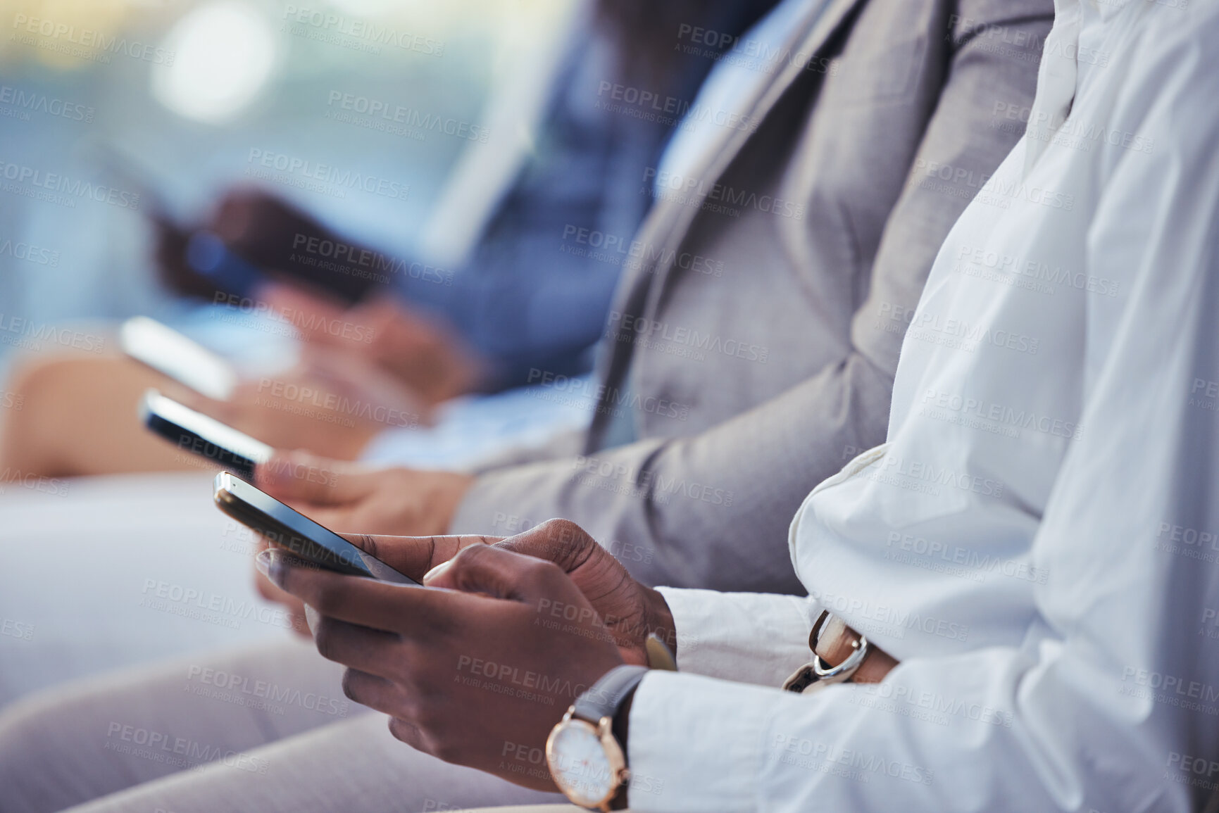 Buy stock photo Hands, phone and human resources with a group of people waiting in line for an interview or meeting. Mobile, hiring and recruitment with business collegues sitting in an hr candidate shortlist row