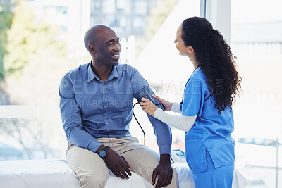 Buy stock photo Black man, doctor and blood pressure healthcare in hospital for health insurance consultation. Patient and professional nurse woman talking about hypertension, wellness and advice for healthy life