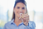 Closeup, woman and ear piece for hearing, healthcare tech and blurry with girl, wellness and  help. Female, happy lady and listening device with smile, medical innovation or disability with insurance