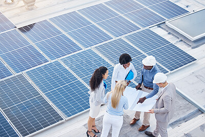 Buy stock photo Solar energy, design or engineering team on roof building sustainable future electricity technology innovation. Collaboration, top or black man talking or planning a construction project with people