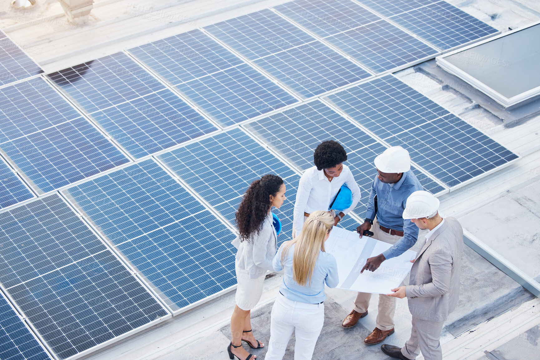 Buy stock photo Solar energy, design or engineering team on roof building sustainable future electricity technology innovation. Collaboration, top or black man talking or planning a construction project with people