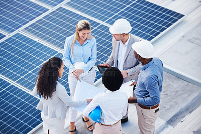 Buy stock photo Solar and renewable energy, blueprint or engineering team on roof building electricity technology for sustainability. Collaboration, top view or black man talking or planning a project with people