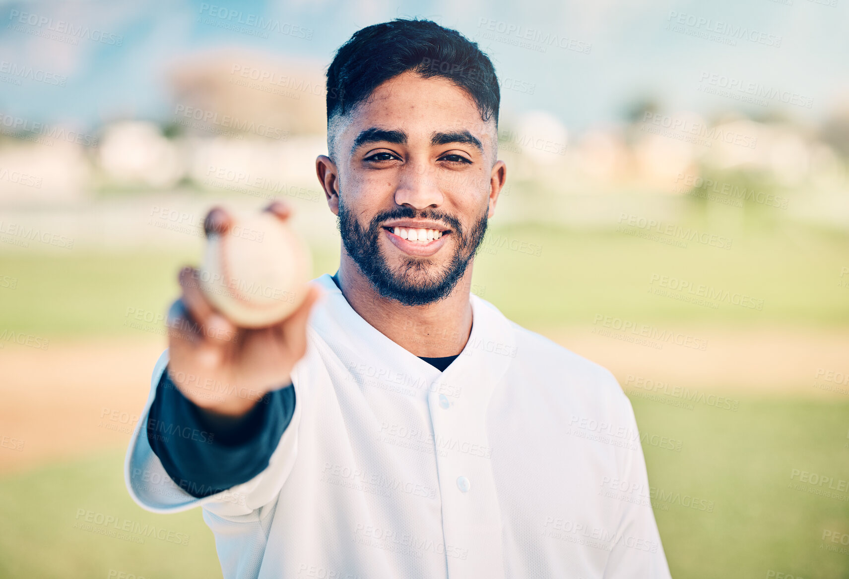 Buy stock photo Baseball player, portrait and sportsman holding ball on match or game day on a sports field or pitch feeling happy. Sport, athlete and pitcher at training with a smile due to health and wellness