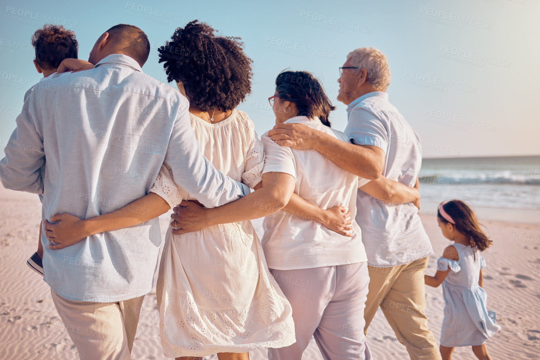 Buy stock photo Big family hug, love and beach walking, bonding or enjoy quality time together for vacation, holiday peace or freedom. Ocean sea, summer travel and back view of relax people in Rio de Janeiro