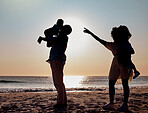 Sunset silhouette, beach and family play, bond or enjoy quality time together for vacation love, holiday peace or freedom. Ocean sea water, nature travel shadow or fun nature people in Toronto Canada