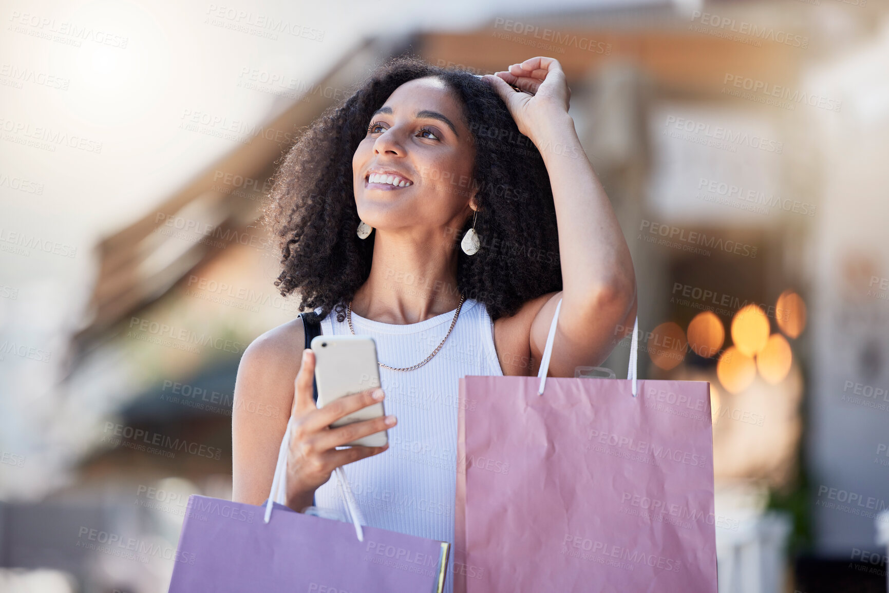 Buy stock photo Black woman, phone and retail shopping bag of a customer on a online shop app for discount. Store promotion, urban and ecommerce mobile networking of a female on a city street with blurred background