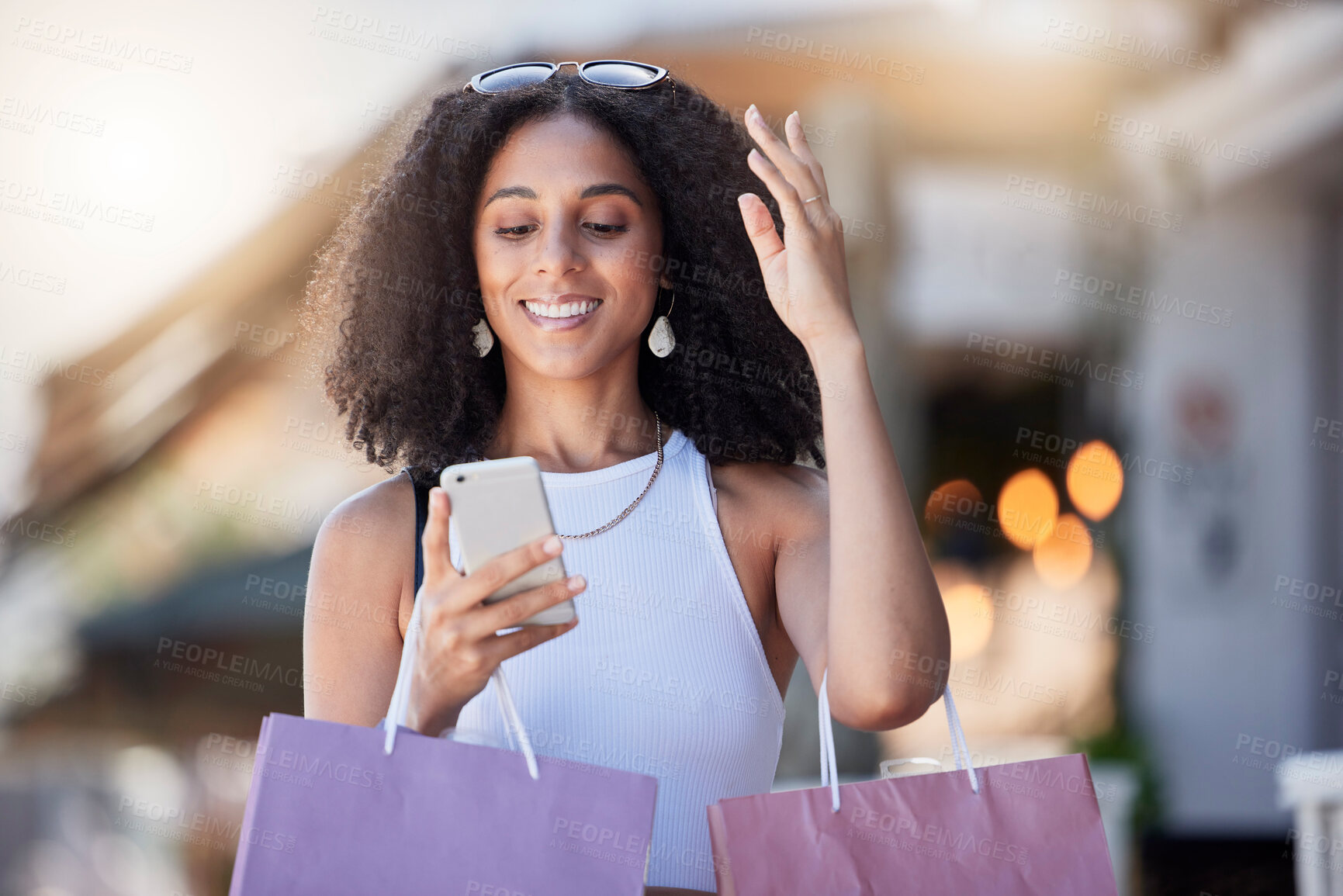 Buy stock photo Black woman smile, phone and shopping bag of a customer on a online shop app for discount. Retail store promotion, urban and mobile networking of a female on a city street with blurred background