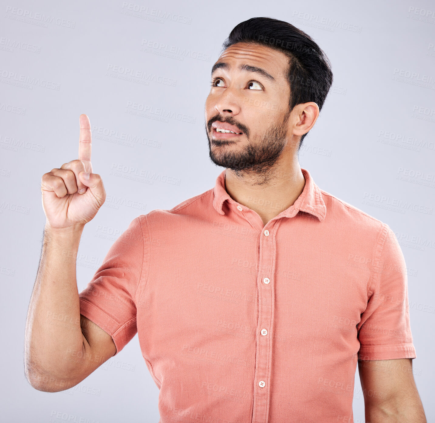 Buy stock photo Mockup, Asian man and pointing for space, advertising and happiness against grey studio background. Japan, male and guy with gesture for product placement, branding or gen z with confidence and relax