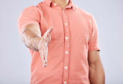 Buy stock photo Onboarding, handshake and portrait of a businessman in isolated, gray background in studio. Shaking hands, agreement and yes hand gesture of young man with contract and thank you hands sign for deal