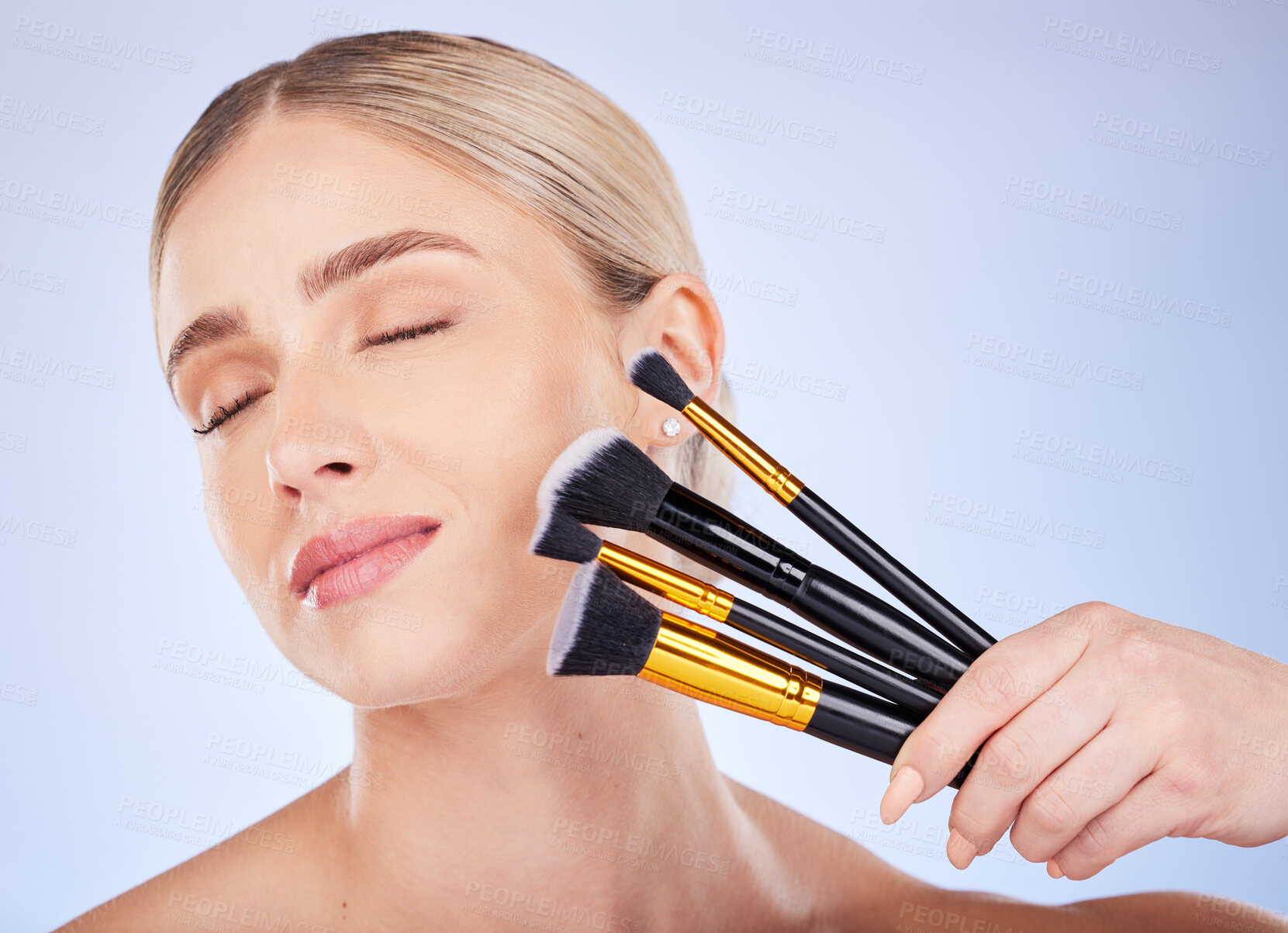 Buy stock photo Eyes closed, face and makeup of woman with brushes in studio isolated on a blue background. Facial cosmetics, beauty skincare and female model with tools to apply foundation or powder for aesthetics.