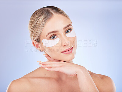 Buy stock photo Face, skincare and woman with eye patches in studio isolated on a blue background. Dermatology portrait, cosmetics and beauty of female model with facial mask for healthy skin, anti aging or collagen