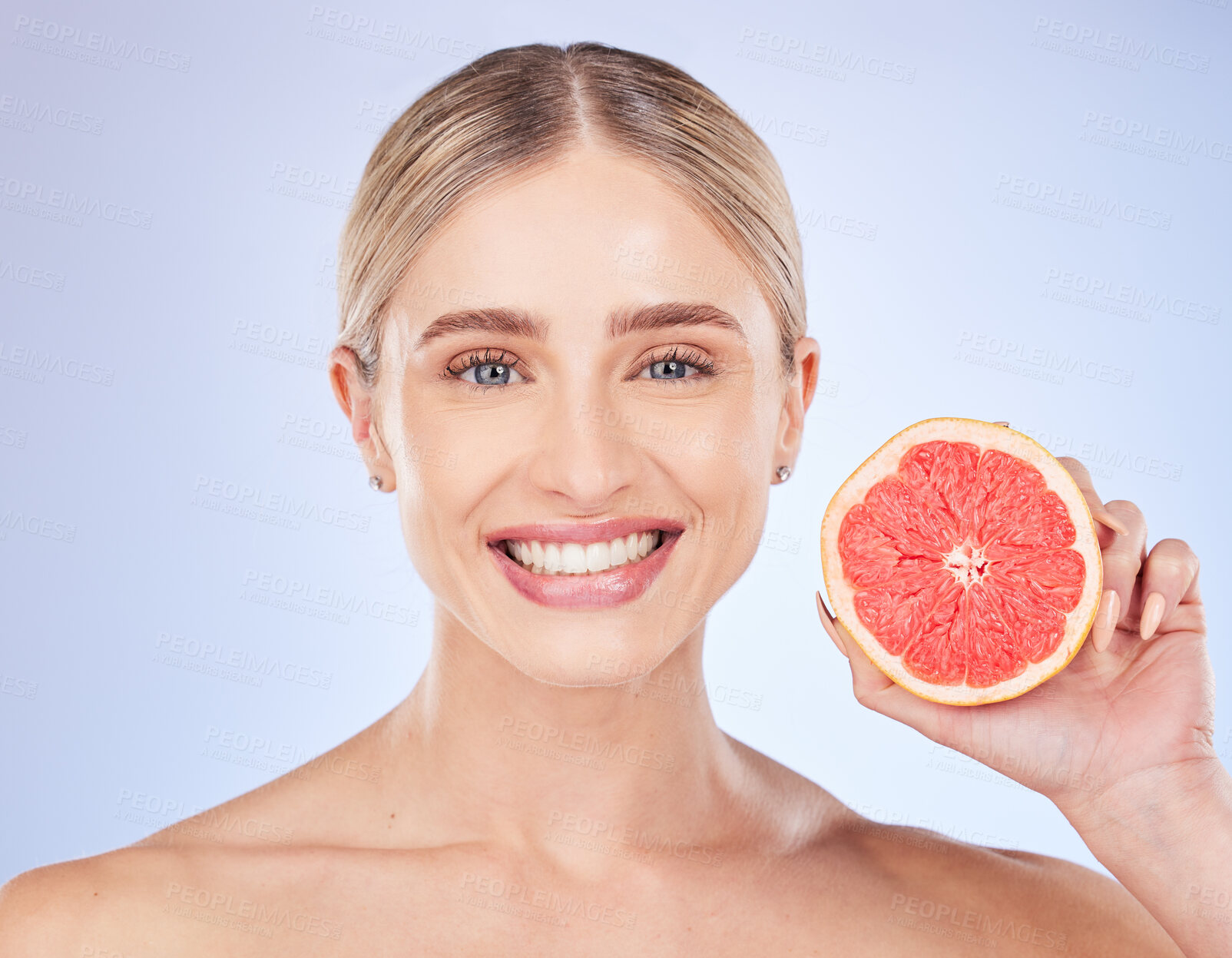 Buy stock photo Face portrait, skincare and woman with grapefruit in studio isolated on a blue background. Food, fruit and happy female model with citrus for vitamin c, nutrition or diet, healthy skin or beauty.