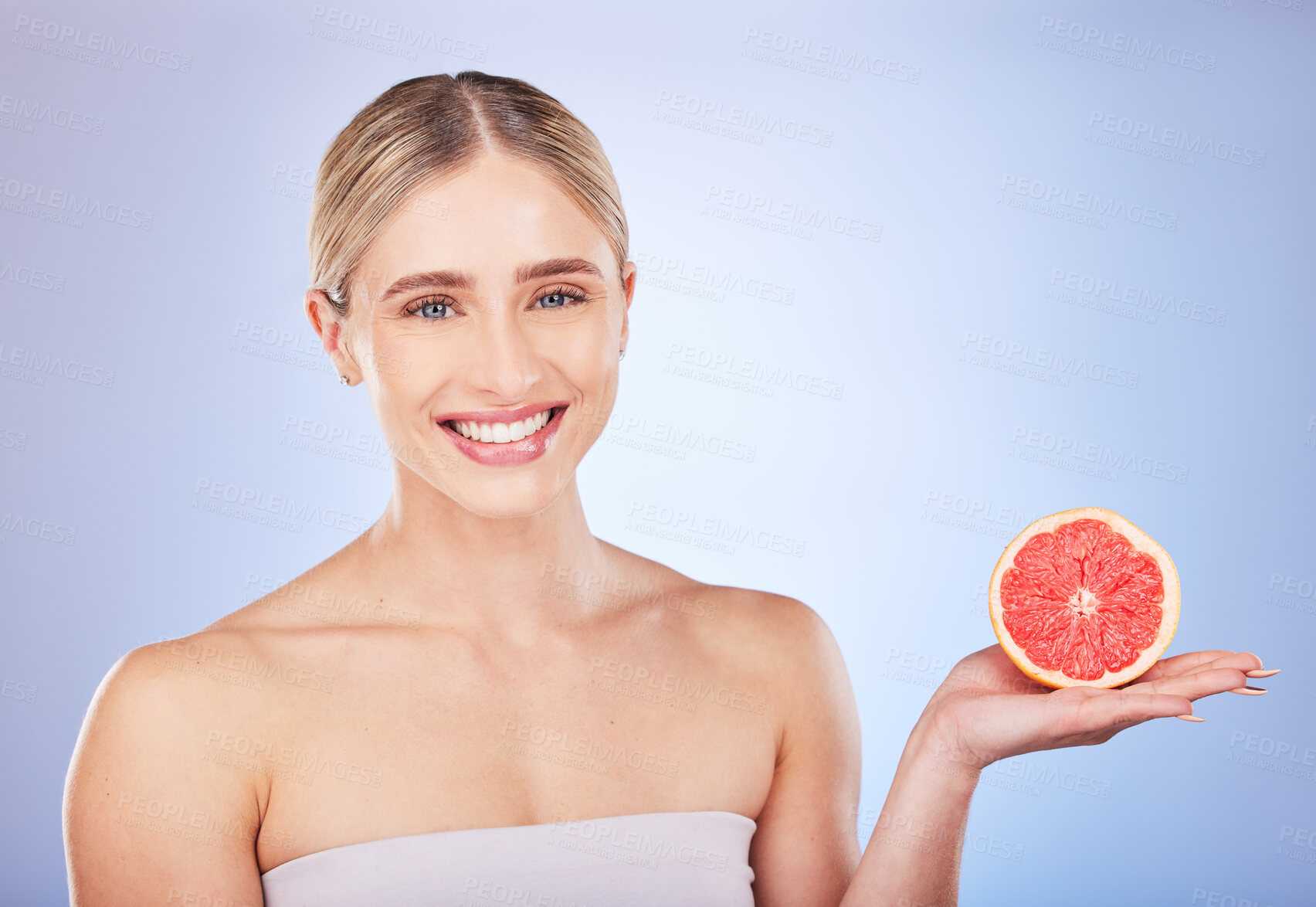 Buy stock photo Skincare, face portrait and woman with grapefruit in studio isolated on a blue background. Food, fruit and happy female model with citrus for vitamin c, nutrition or diet, healthy skin or beauty.