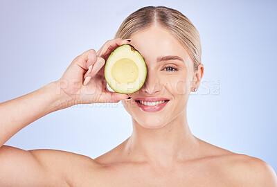 Buy stock photo Skincare, face portrait and woman with avocado in studio isolated on a blue background. Cosmetics, fruit and happy female model holding food for omega 3, nutrition or diet, healthy skin or beauty.