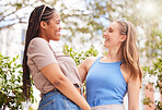 Summer, diversity and friends happy in the park together, laughing while bonding outdoor in nature. Spring, smile and women in a garden, having fun while enjoying a joke or humor over the weekend