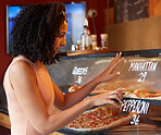 Choice, hungry and woman buying pizza for lunch with a decision, looking and choosing at a shop. Food, happy and girl picking a fast food option at a restaurant for a take away purchase at a cafe