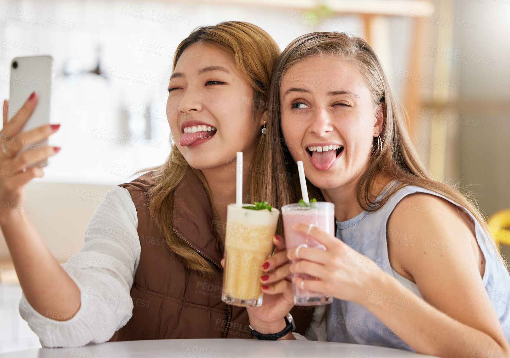 Buy stock photo Selfie, wink or funny friends take profile picture in cafe with happy smile on holiday vacation or weekend. Crazy faces, Asian or young women smiling for social media posts brunch date with cocktails