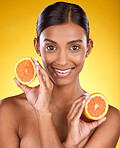 Skincare, smile and portrait of Indian woman with orange slice and facial detox with smile on yellow background. Health, wellness and face of model with organic luxury cleaning and grooming cosmetics