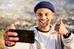 Fitness, hiking and man taking a selfie on the mountain after walking for a exercise in nature. Sports, health and young male hiker taking a picture while trekking outdoor for a cardio workout.