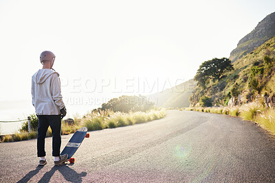 Skateboard, mountain and man in road for sports competition, training and exercise in urban city. Skating mockup, thinking and male skater standing in street for challenge, adventure and freedom