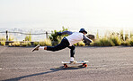 Skateboard, moving and man in road for sports competition, training and exercise in urban city. Skating, skateboarding and male skater in action for speed, adventure and freedom for extreme sport