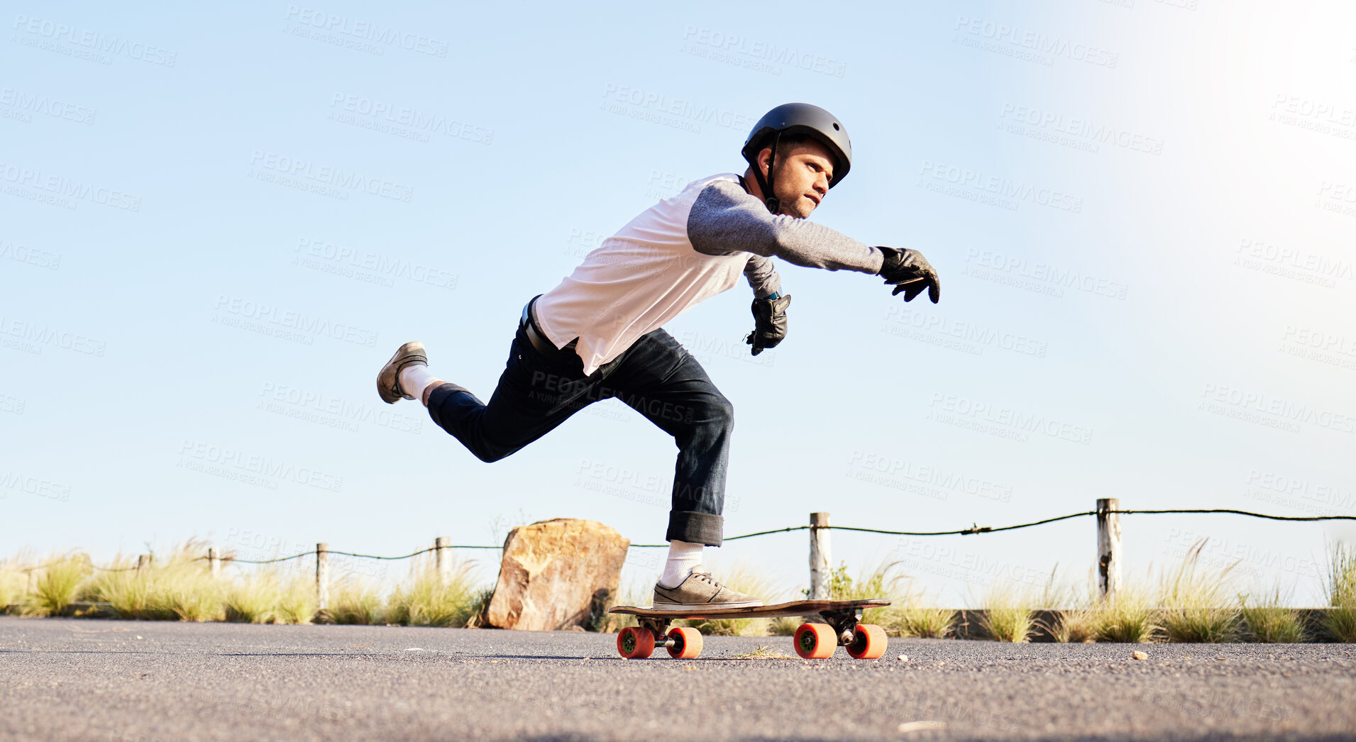 Buy stock photo Skateboard, sports action and man in road for competition, training and exercise challenge in city. Skating, skateboarding and male skater with focus for speed, adventure and freedom in extreme sport