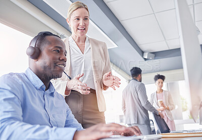 Buy stock photo Call center, black man and manager talking at computer desk for support, advice or help with telemarketing. Consultant or agent with mentor woman for CRM, customer service or contact us communication