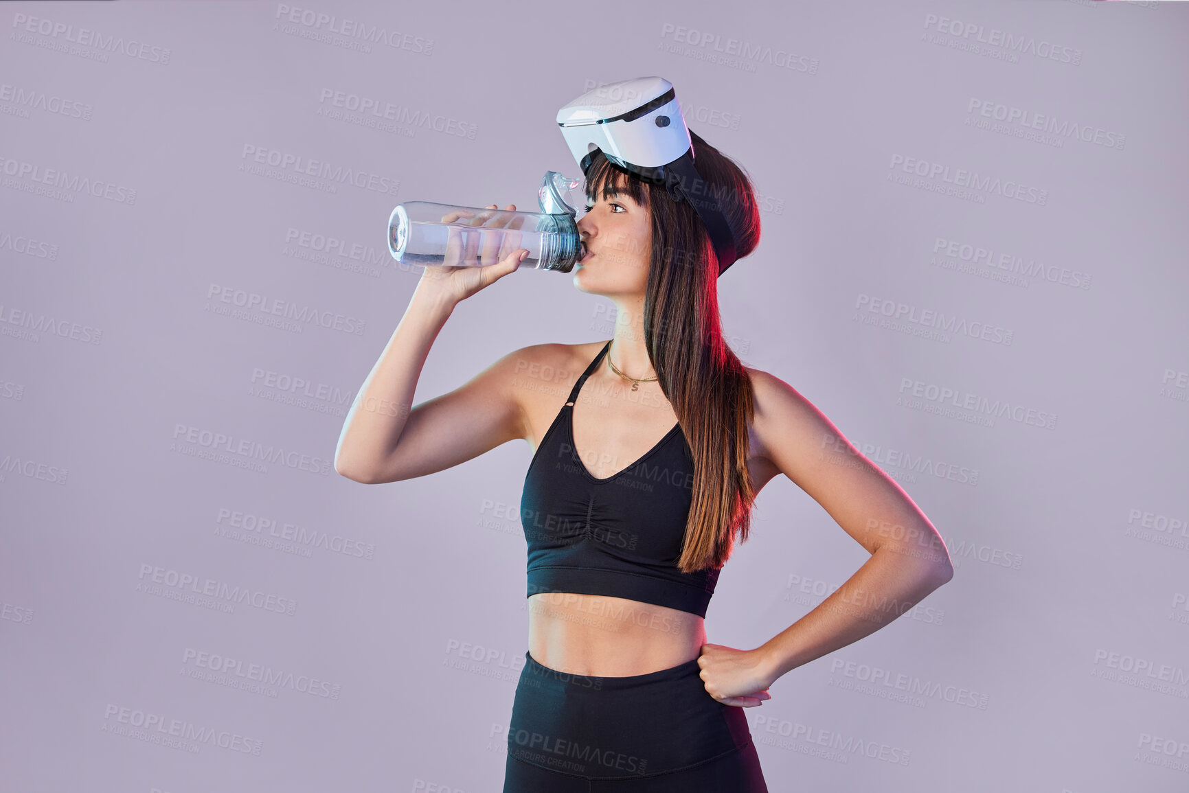 Buy stock photo Fitness woman, drinking water and VR for exercise, training or simulation against a studio background. Thirsty female with bottle for refreshment after intense virtual reality workout on mockup