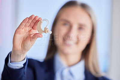 Buy stock photo Hands, hearing aid and deaf business woman with listening device for healthcare, wellness and disability. Closeup of audiology plug for female worker, professional and ears with communication sound

