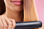 Closeup, woman and hair straightener for care, texture and beauty against a studio background. Zoom, female and girl with salon tool, treatment and grooming for confidence, aesthetic and cosmetics