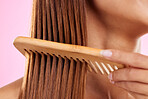 Beauty, comb and bamboo with hair of woman for health, salon and satisfaction in studio. Wellness, keratin and natural with girl model and self care for cosmetics, brush and shine on pink background