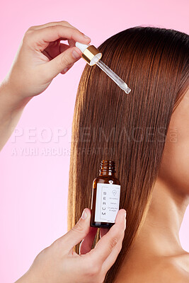 Buy stock photo Closeup, woman and hair care with oil, pipette and luxury salon treatment against a studio background. Zoom, female and lady with scalp product, volume and wellness for shine, growth and grooming