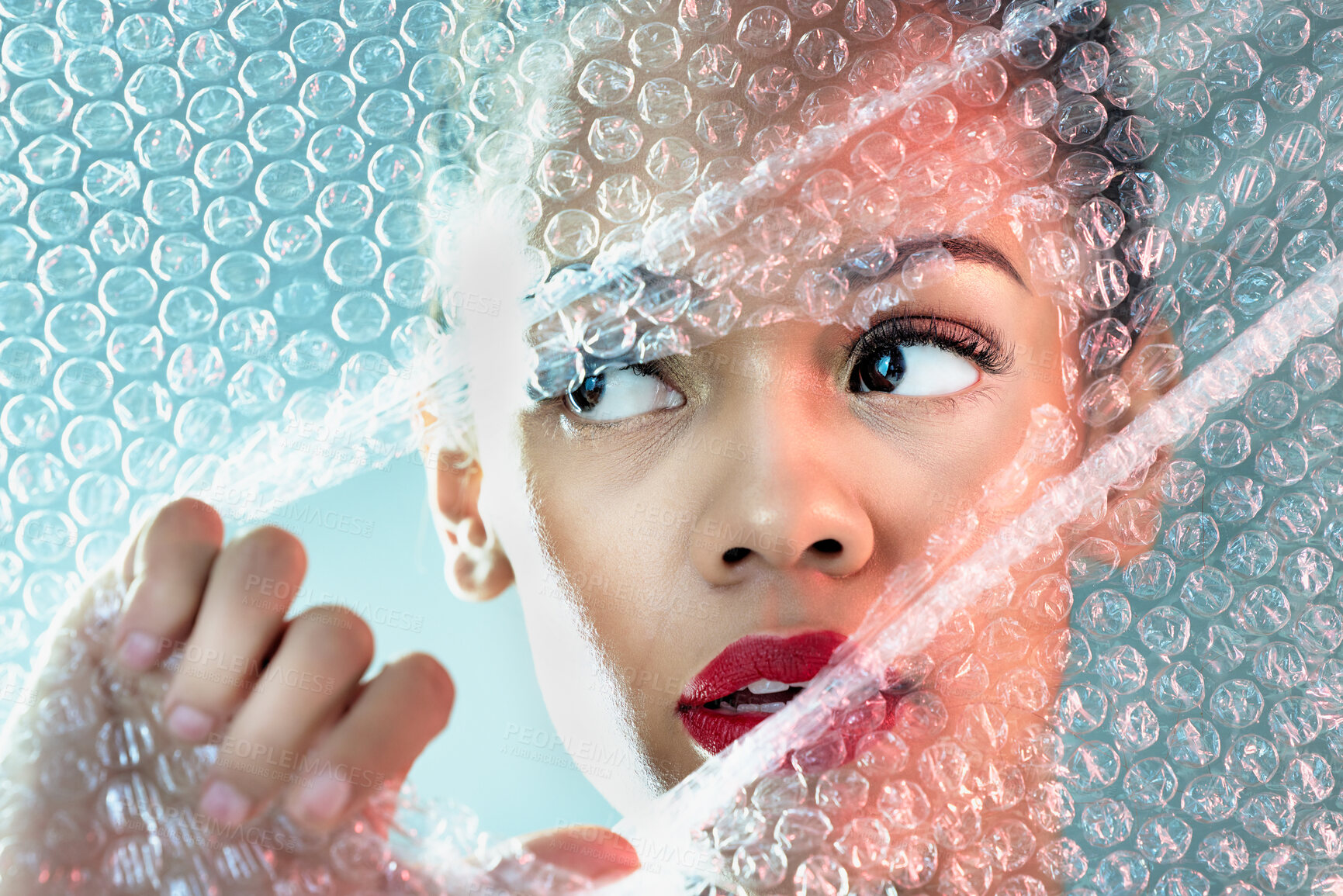 Buy stock photo Bubble wrap, beauty and face of woman with makeup, cosmetics and skincare products in studio. Creative art deco, salon aesthetic and thinking girl with glow, lipstick and luxury style with plastic
