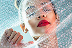 Beauty, bubble wrap and makeup with breakthrough with black woman for package, creative and cosmetics. Plastic, confidence and glow with girl model and red lipstick for facial, art and glow in studio