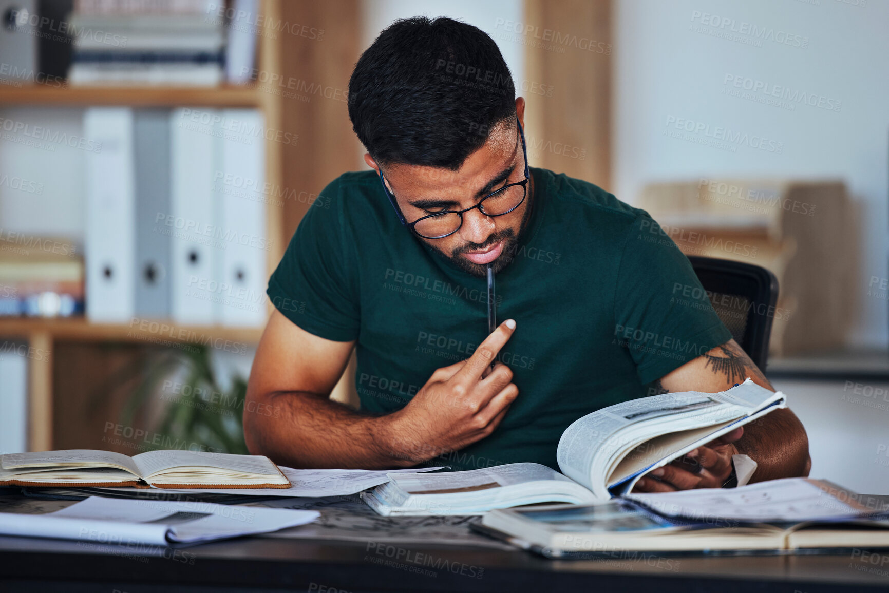 Buy stock photo Student, black man and books to study on home desk thinking, reading and studying for college. Person learning and focused on information on page for education, knowledge and working on law research