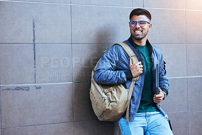 Buy stock photo Happy, laughing and man on a wall for education, studying and university in the city. Smile, looking and student ready to start college on a campus for learning, scholarship and excited about school