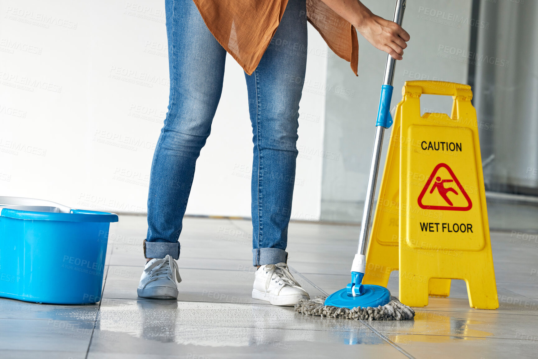 Buy stock photo Cleaning, wet floor caution and woman mopping in building for maintenance, health or hygiene. Mop, janitor service and cleaner with warning notice, sign or safety information on slippery ground tiles