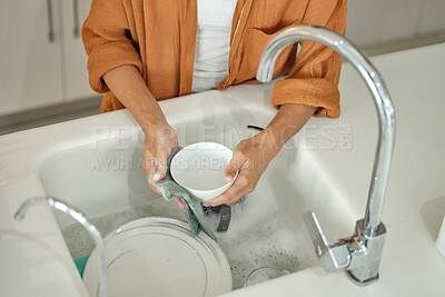 Buy stock photo Housework, kitchen and woman washing the dishes for hygiene and cleanliness in her modern house. Maid, cleaner and housewife cleaning the tableware for dirt with soap, water and a cloth in her home.