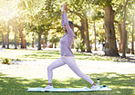 Fitness, woman and yoga for spiritual wellness, zen or stretching workout on grass field in nature. Happy woman yogi smiling on mat in warrior pose for calm training, arm stretch or practice at park