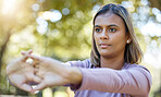 Fitness, nature and woman doing a stretching exercise before a workout in the park or garden. Sports, wellness and female athlete doing a arm warm up workout before pilates training outdoor in field.