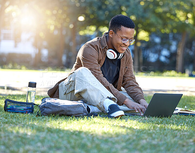Buy stock photo Black man, park studying and laptop work in a campus garden with a smile and lens flare, Outdoor, happiness and online elearning with a textbook of a student busy with exam study on university grass