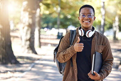 Buy stock photo Black man, portrait or thumbs up on campus, park nature or garden in college review, university like or school vote. Smile, happy or student with thumb hands for learning success or education growth