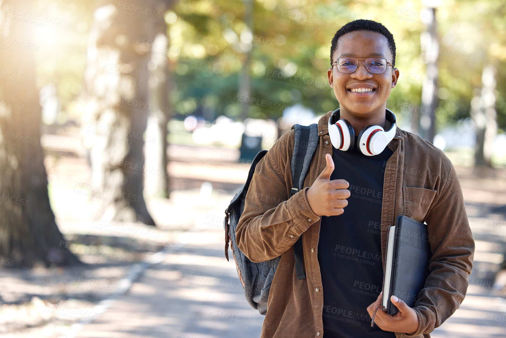 Buy stock photo Black man, portrait or thumbs up on campus, park nature or garden in college review, university like or school vote. Smile, happy or student with thumb hands for learning success or education growth