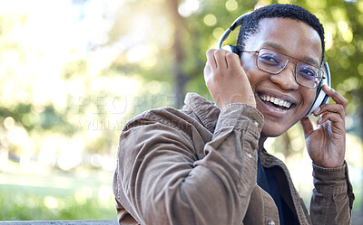 Buy stock photo Headphones, park and portrait of black man listening to music for outdoor, mental health and relaxing break in nature. Young african student or happy person with audio technology in garden or campus