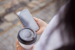 Phone, coffee and pov with a woman in the city browsing social media or typing a text message from above. Contact, texting and 5g mobile technology with a female person outside in an urban town