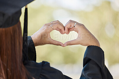 Buy stock photo Student graduation, heart hand sign and education achievement outdoor with blurred background. University, college success and love emoji hands gesture from education event and graduate woman